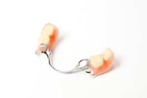 a partial denture acting as a replacement tooth. Implant therapy is another option for multiple teeth replacement