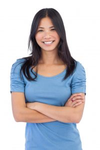A young woman with a beautiful smile that has been restored by dental implants in Calgary