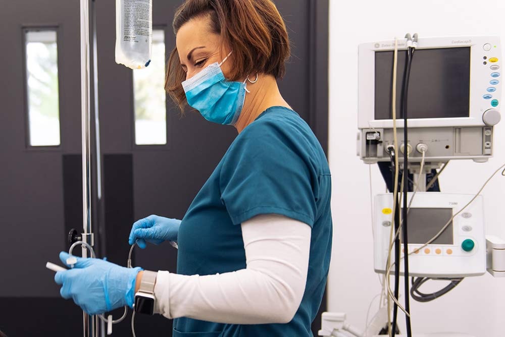 Nurse setting up an I.V for dental procedures