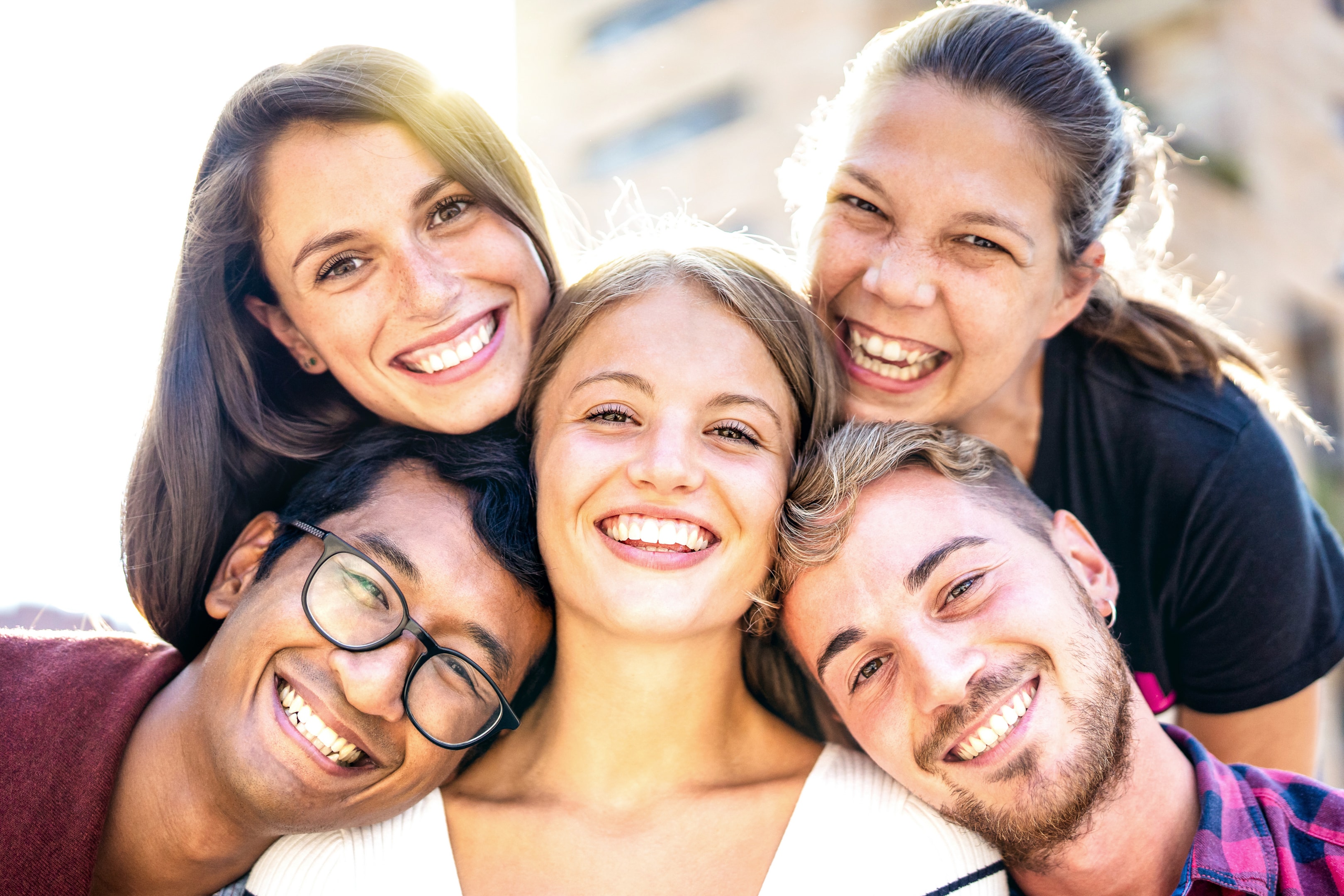 Group of adults smiling after teeth alignment surgery