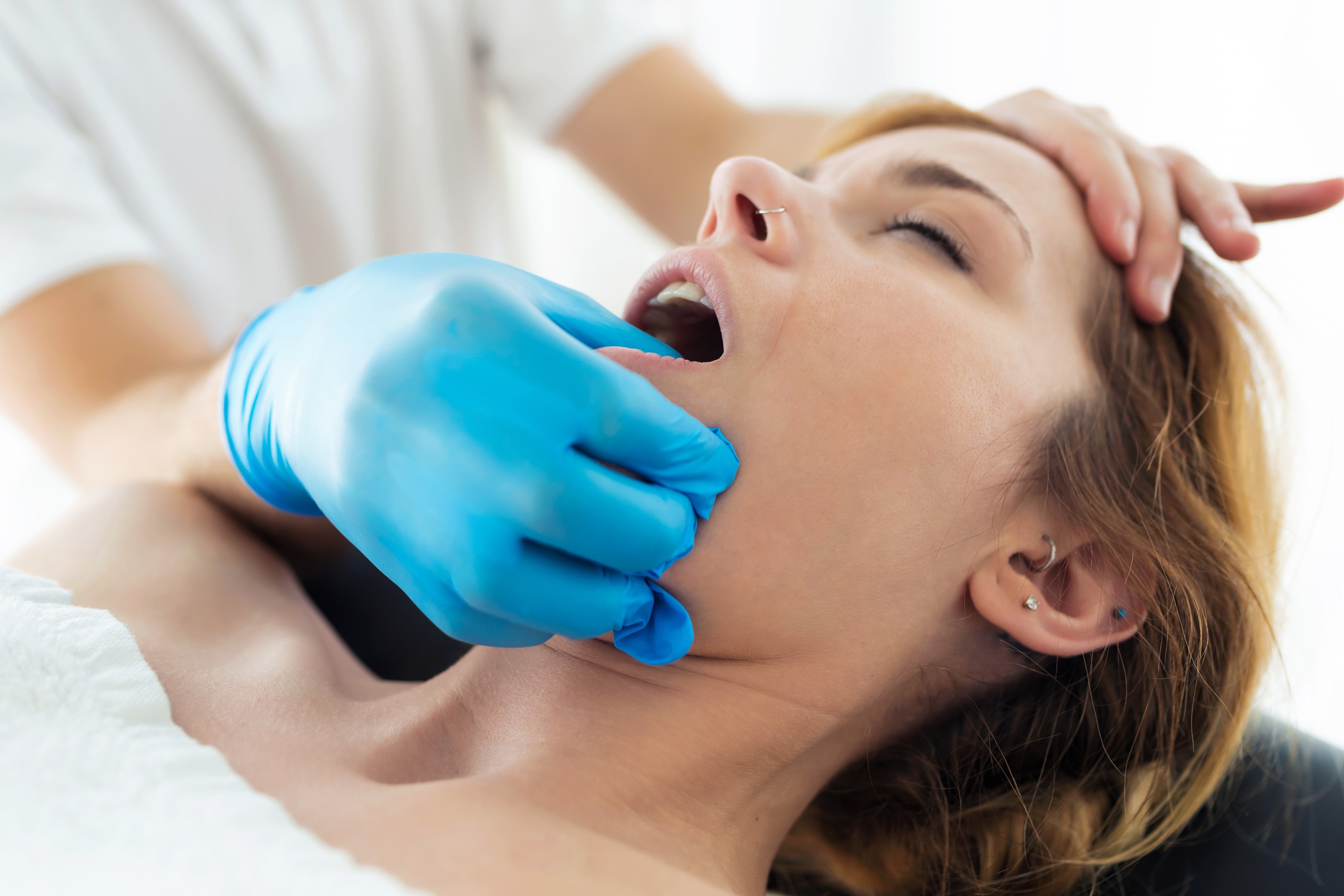 Woman managing pain and discomfort during orthognathic surgery recovery
